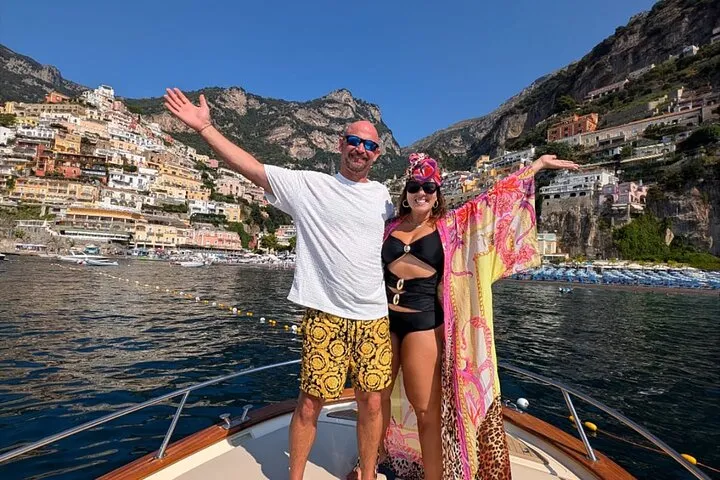 A private boat with a local skipper cruising past cliffside villages on a private boat tour of the Amalfi Coast, Italy