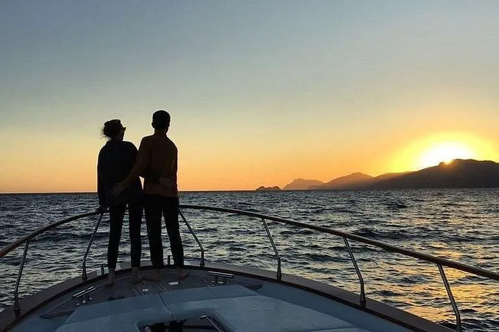A private boat on the water at sunset with a glass of Prosecco on a private boat tour of the Amalfi Coast, Italy